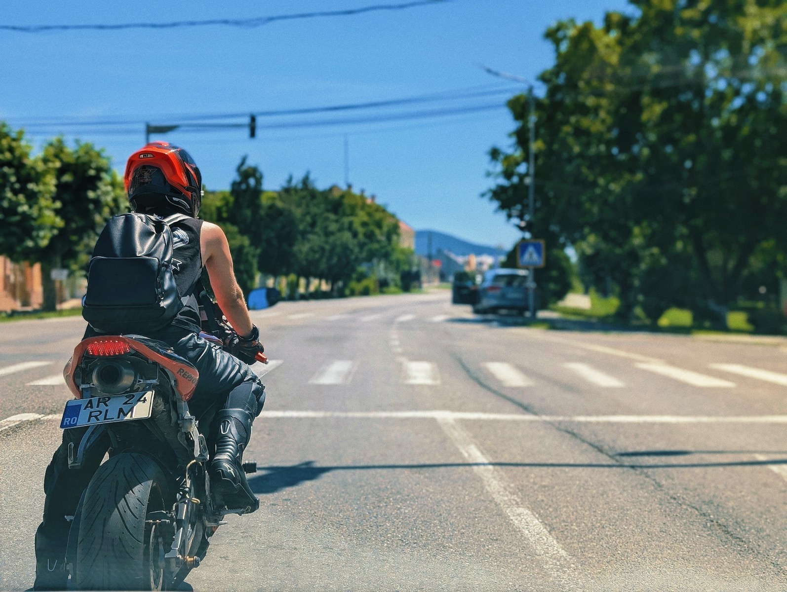 A man riding a motorcycle down a street